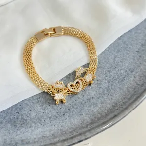 PULSEIRA MALHA COM PINGENTES CORAÇÃO E 2 MENINAS
