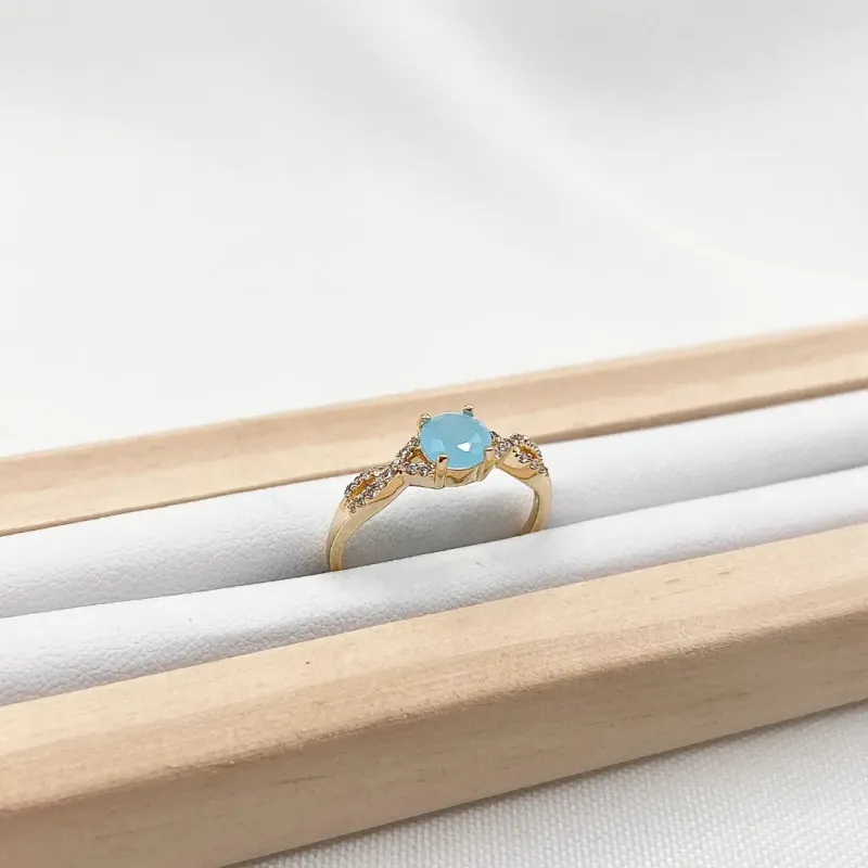 ANEL ARO CRUZADO E CRAVEJADO DE ZIRCONIAS COM PEDRA AZUL LEITOSA ANEL ARO CRUZADO E CRAVEJADO DE ZIRCONIAS COM PEDRA AZUL LEITOSA