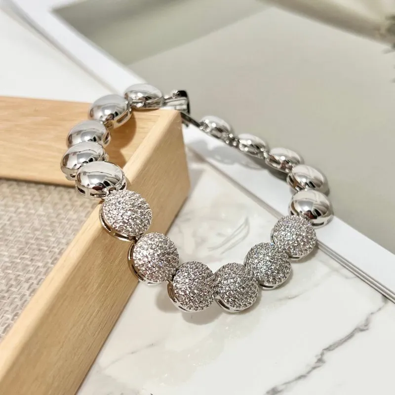 PULSEIRA MEIA ESFERA CRAVEJADA