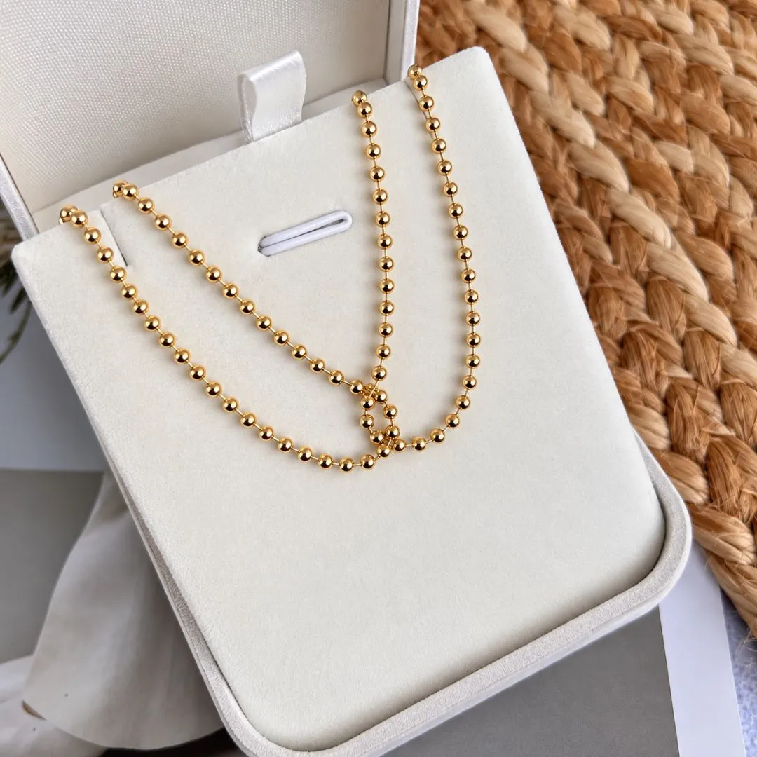 COLAR CHOKER BOLINHAS ENTRELAÇADAS 40CM
